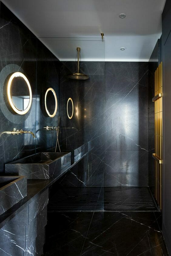 Black marble bathroom with brassware